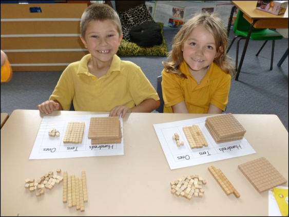 Jacob  and Jade demonstrating the number 467 in maths 